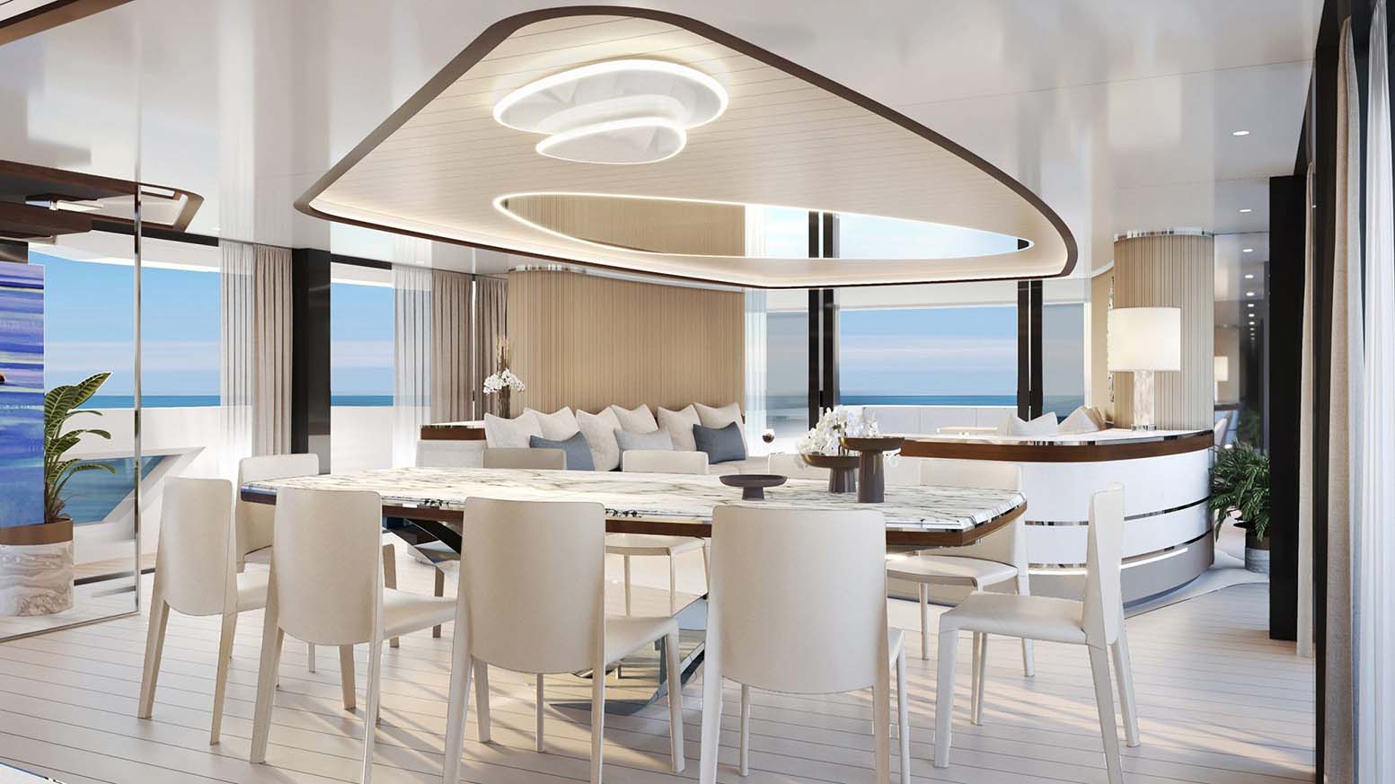 Interior dining table set for ten beneath a sculpted ceiling light