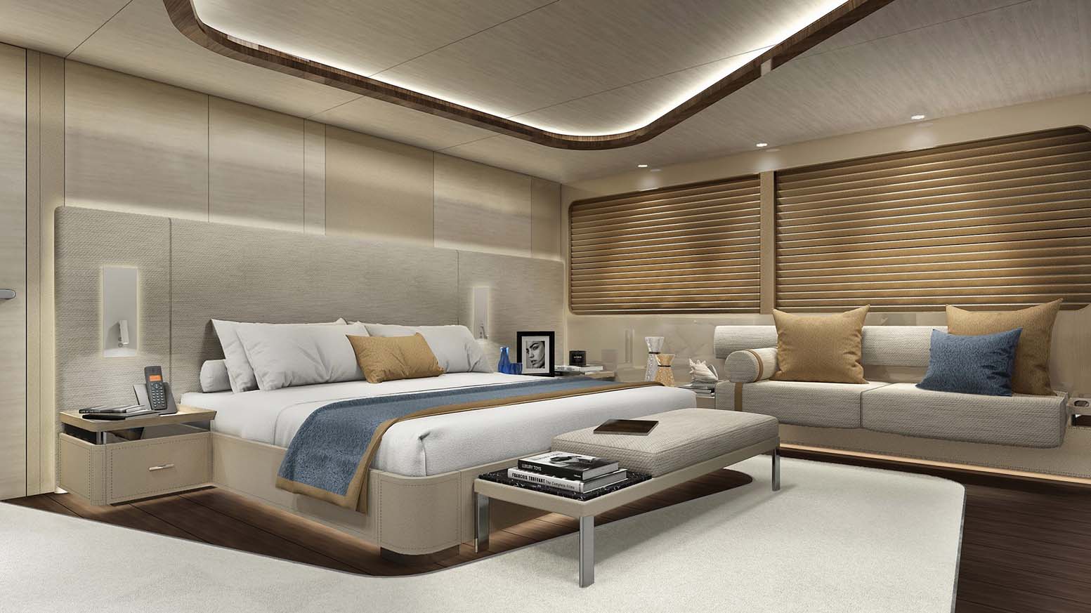 Owner’s stateroom with a double bed, seating and timber panelling