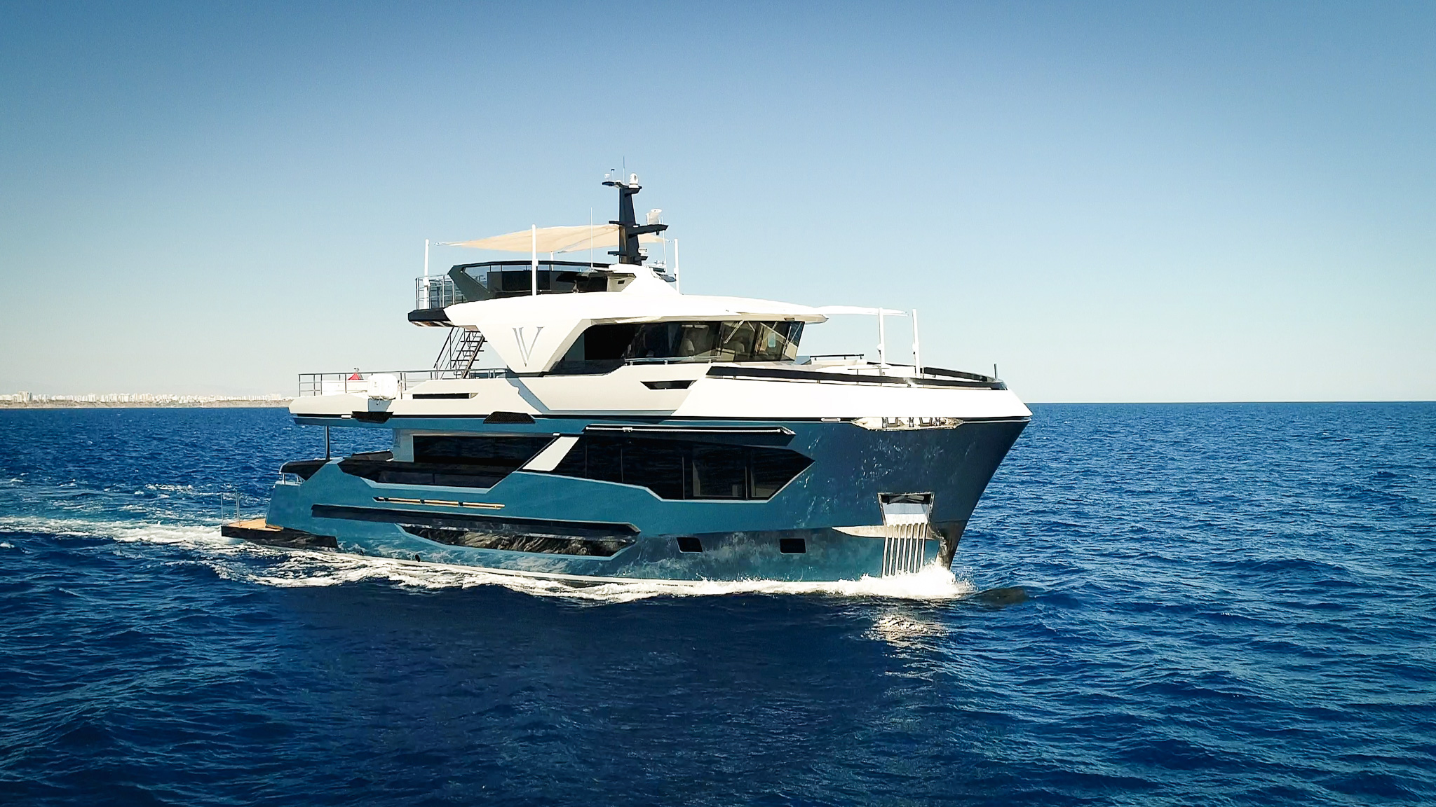 M/Y V at sea showing her four-deck profile
