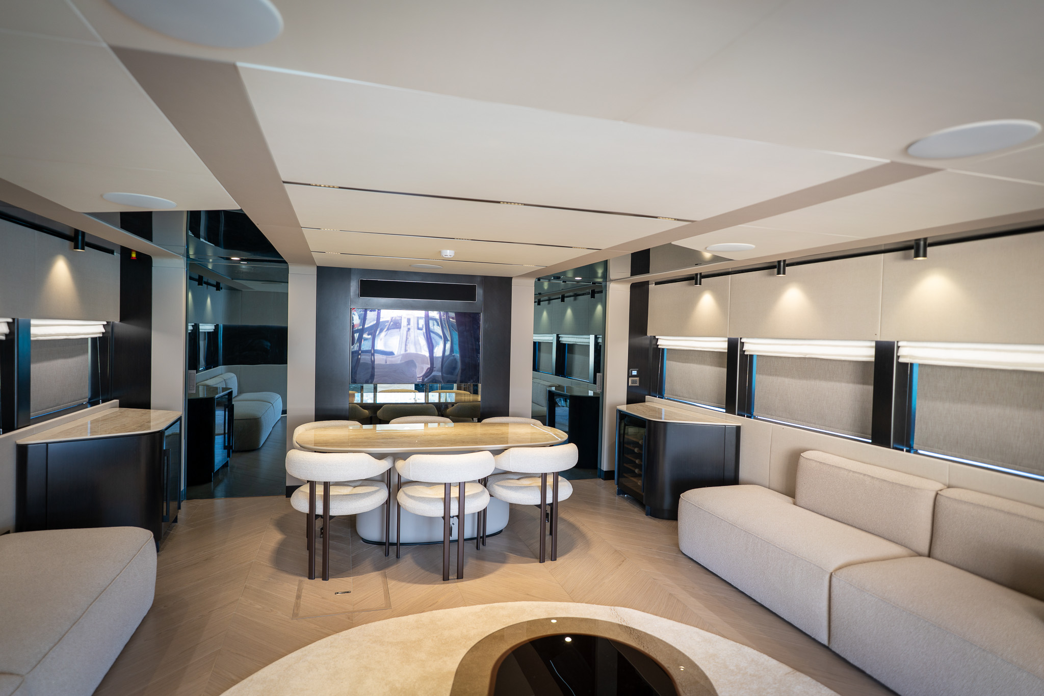 Interior saloon and dining area with pale joinery and seating