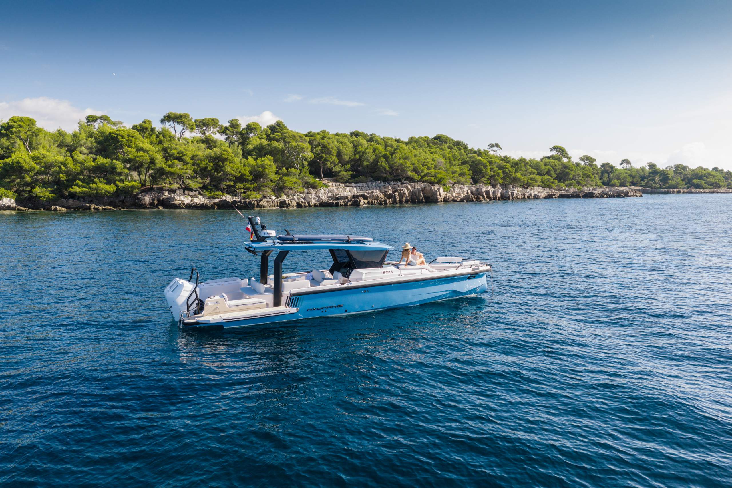 The Axopar 38 Cross Top at anchor in a bay off a wooded island