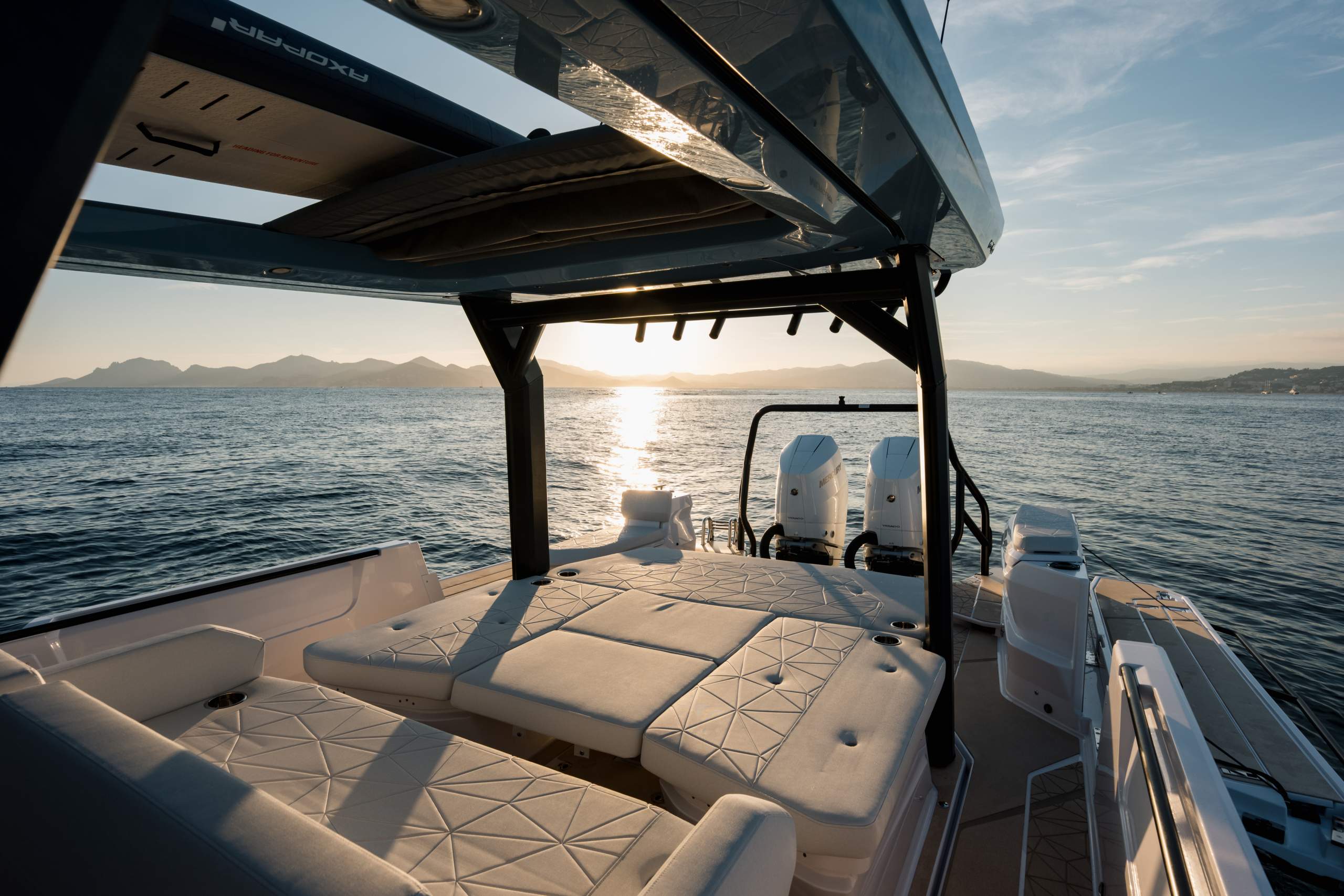 Cockpit seating and sunpad under the hard top at sunset