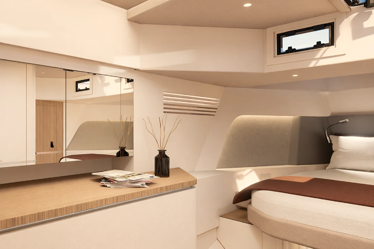 A cabin with a vanity and mirror alongside the berth, lit by a hull-side window.