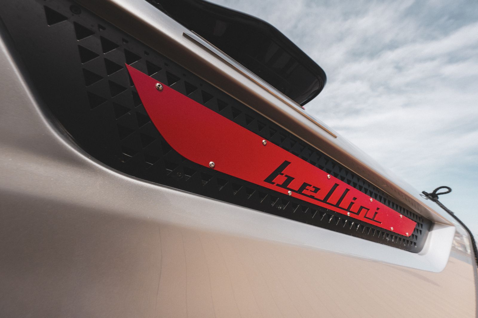A close view of the red bellini graphic set into the perforated black side panel.