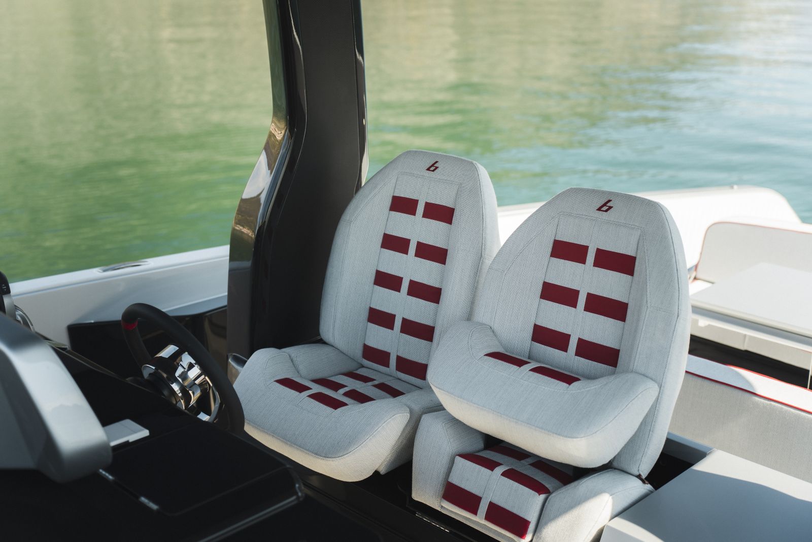 The twin helm seats, upholstered in white with red inserts and the bellini badge.