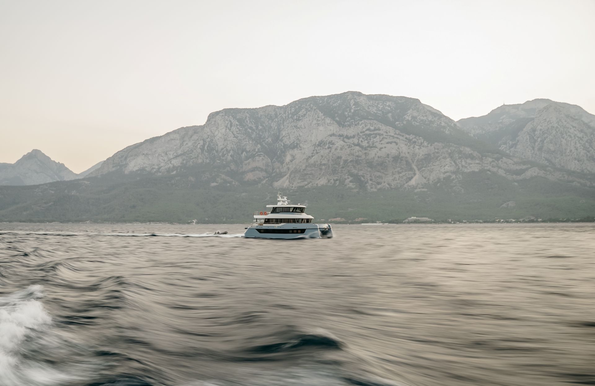 The BC60 under way off a mountainous coast