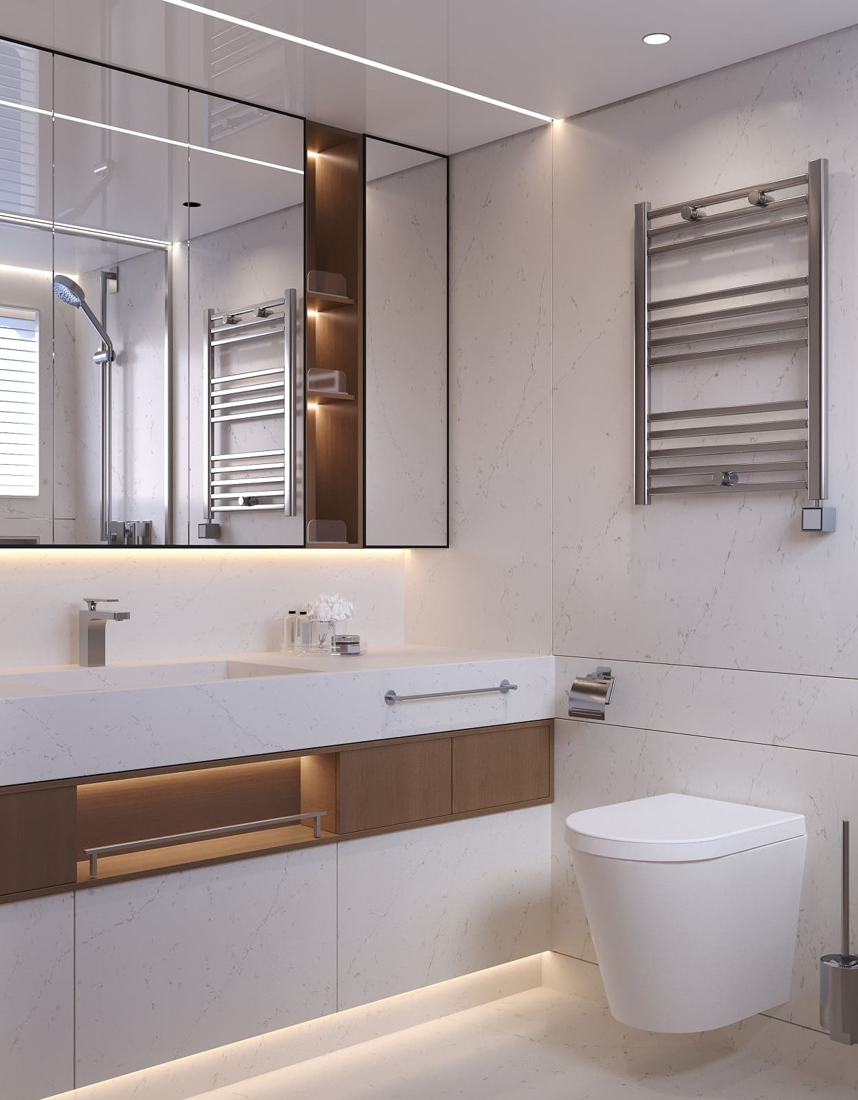 The master bathroom, with a long vanity under a mirror and a heated rail