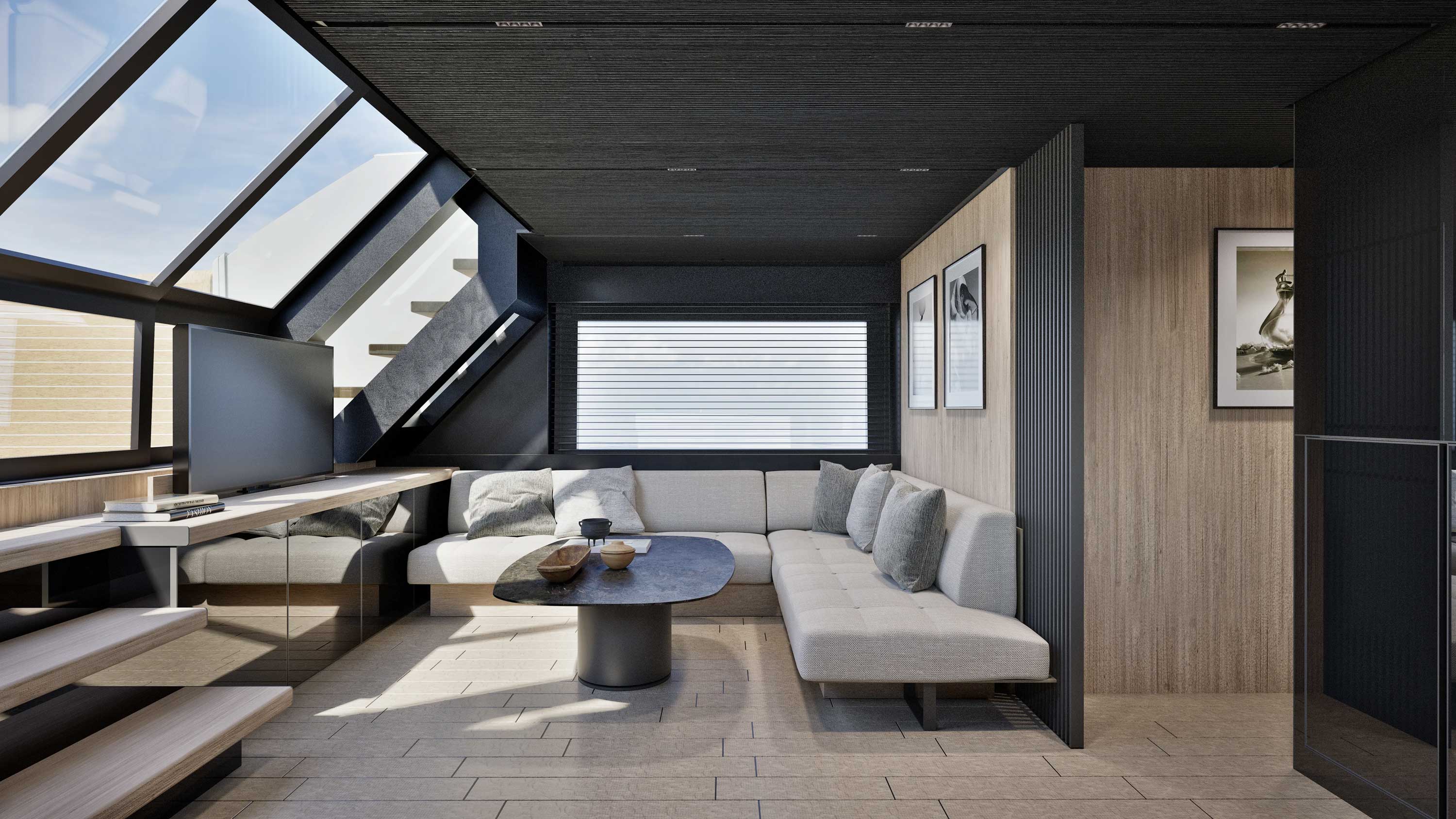 The saloon looking aft, with a sofa and low table under the angled glass