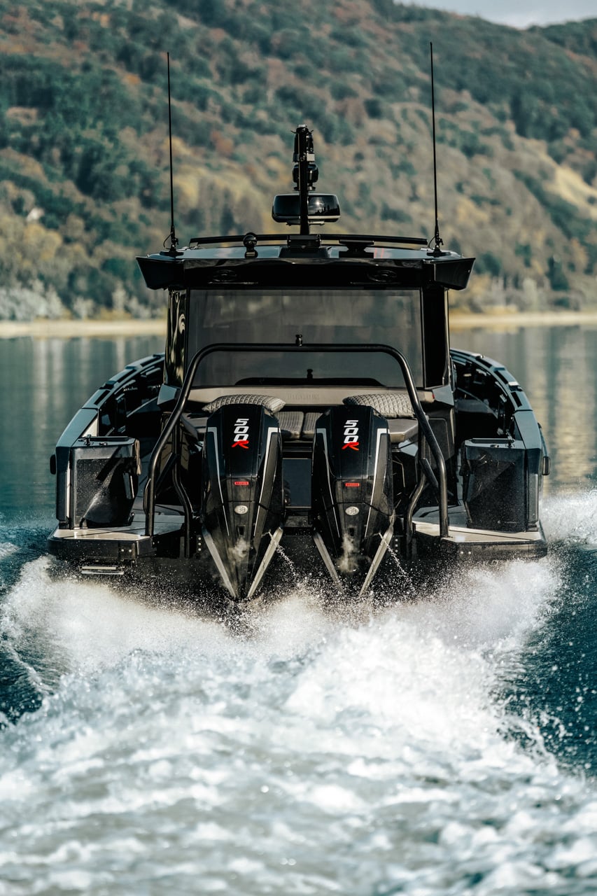 Astern view of the boat running, twin outboards throwing spray