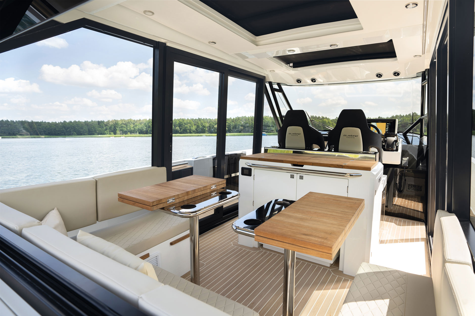 The cabin looking aft past the helm seats and tables