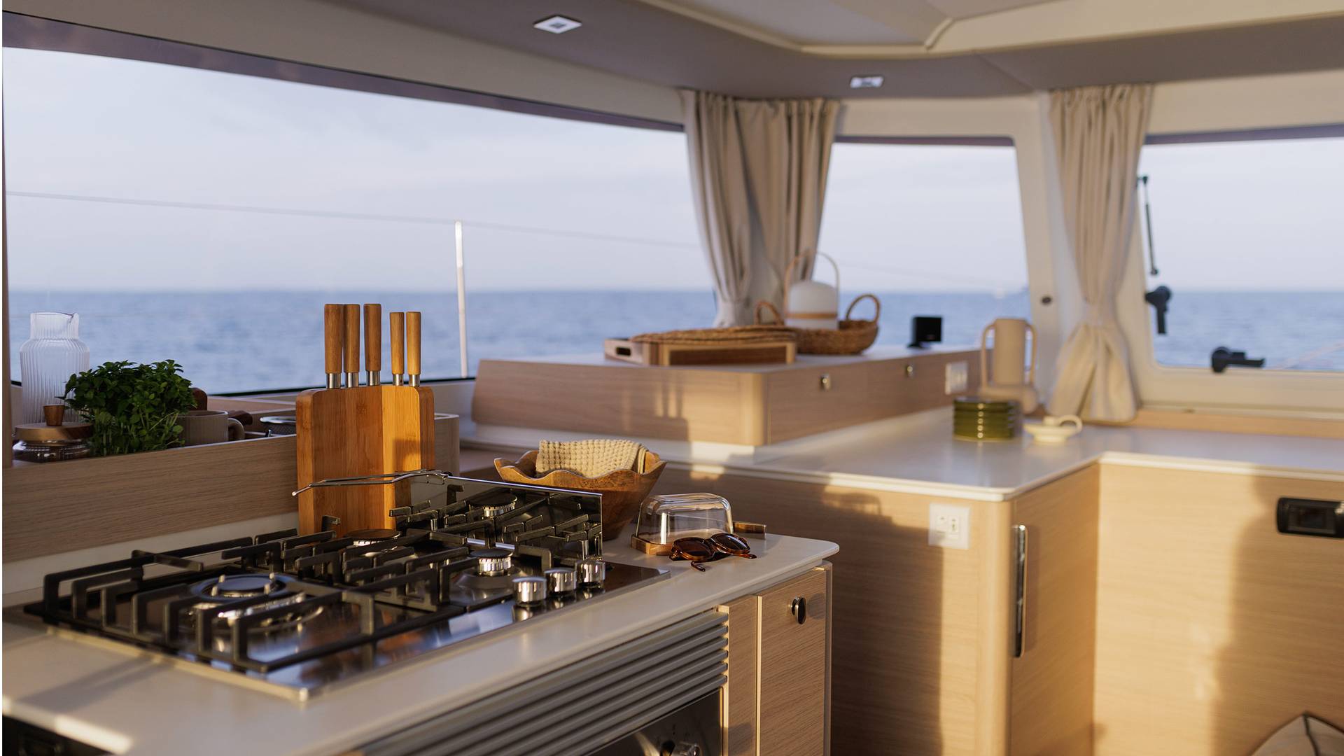 The galley worktop with a gas hob and knives in a block