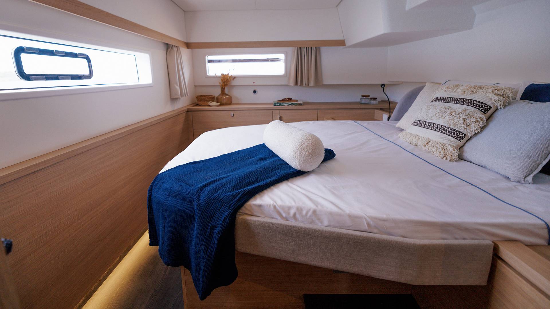 A second double cabin with a long narrow hull window running beside the berth