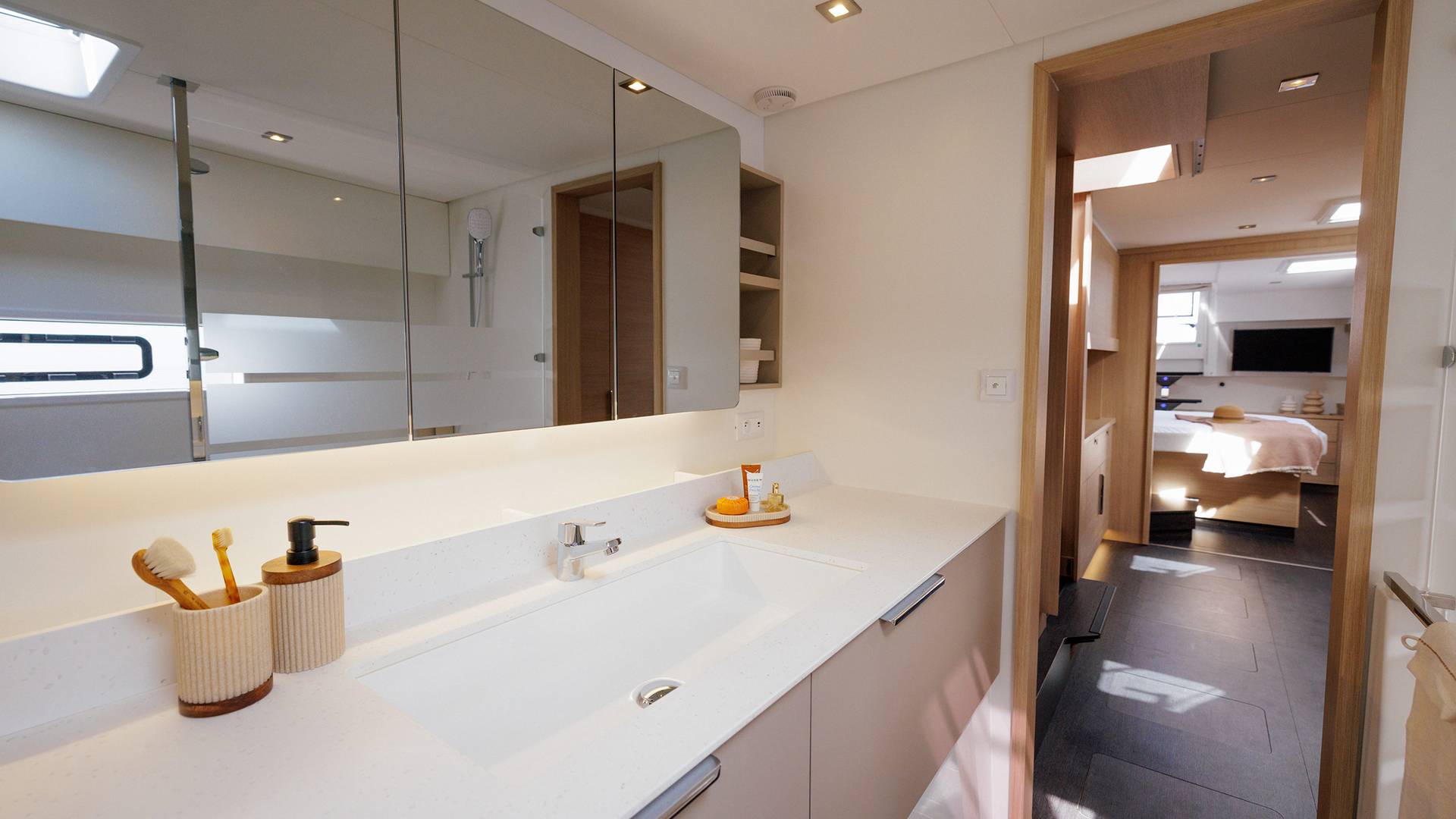 A heads compartment with a long basin unit and a mirror the width of it