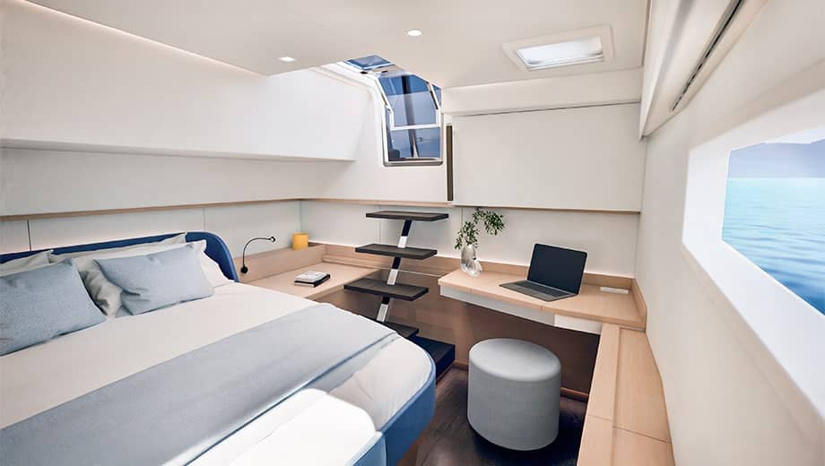 A double cabin with a desk and a hull window above the berth
