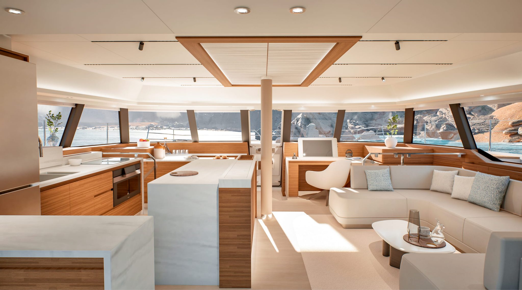The saloon looking aft past the galley island to the sofa and the sea