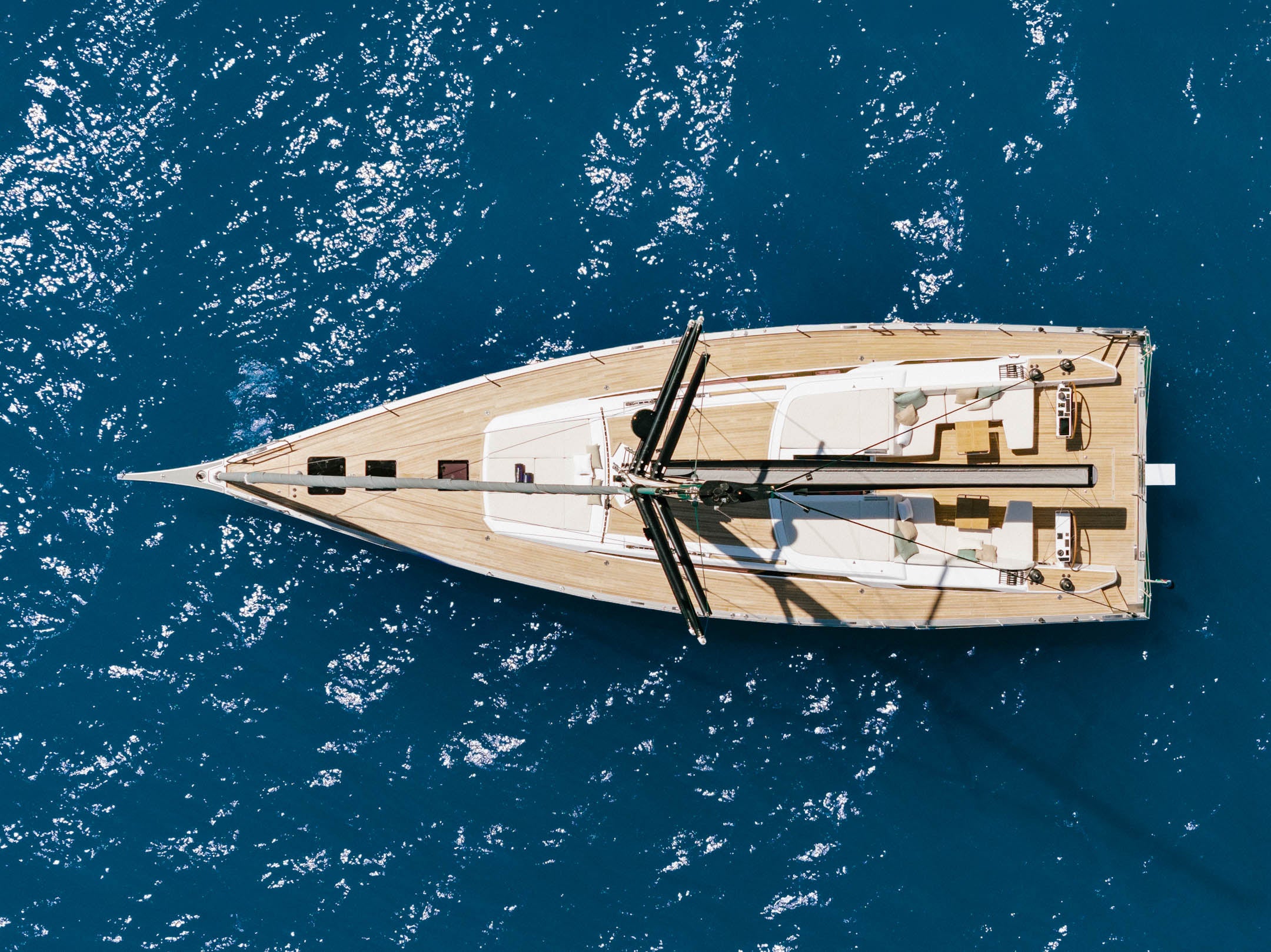 Looking straight down on the deck at anchor, the full sail plan stowed