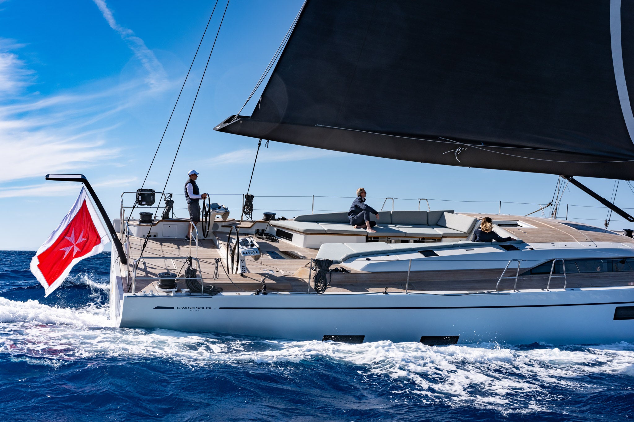 The stern quarter under way with crew in the cockpit