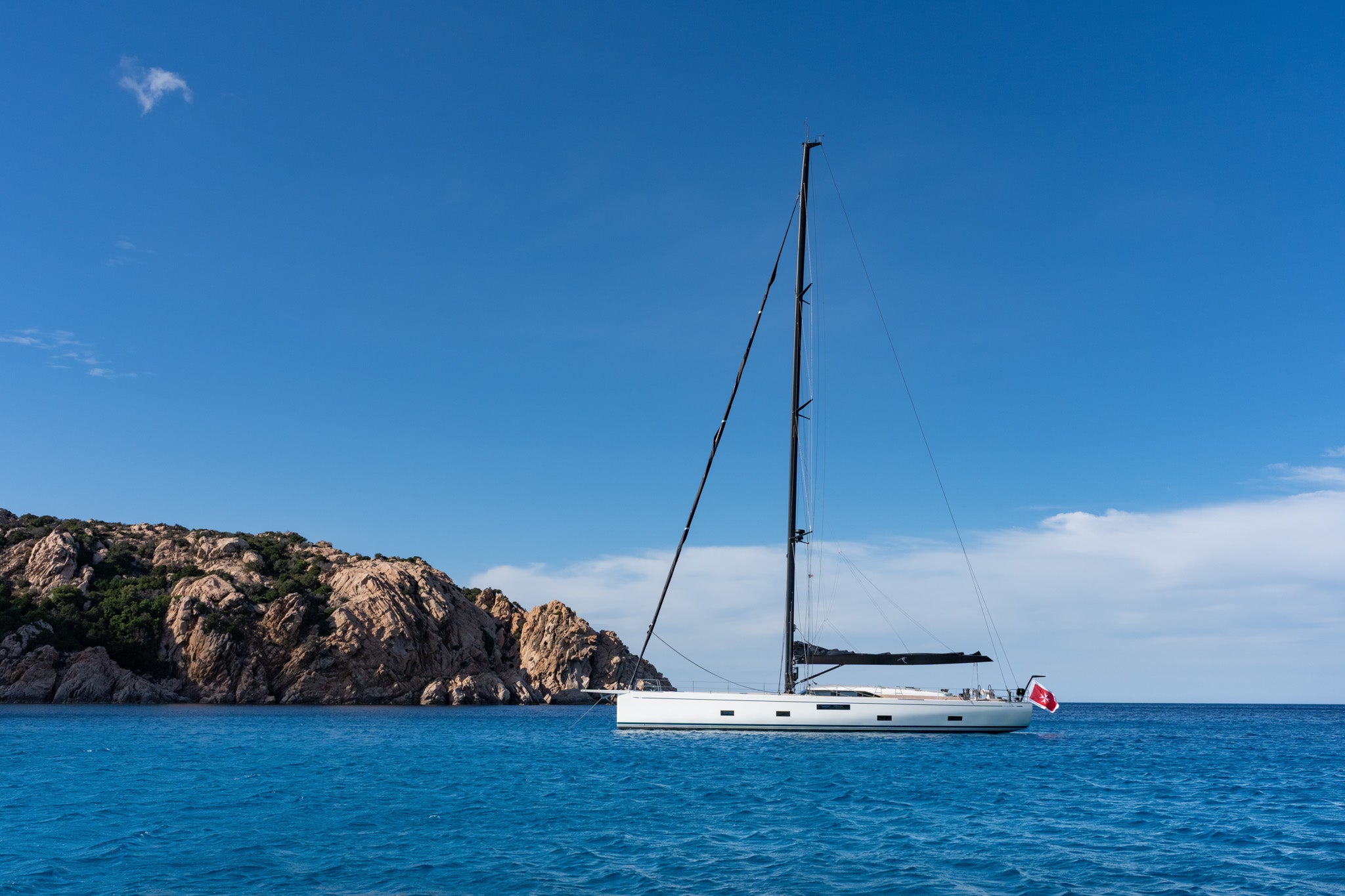 At anchor off a rocky shore in flat water