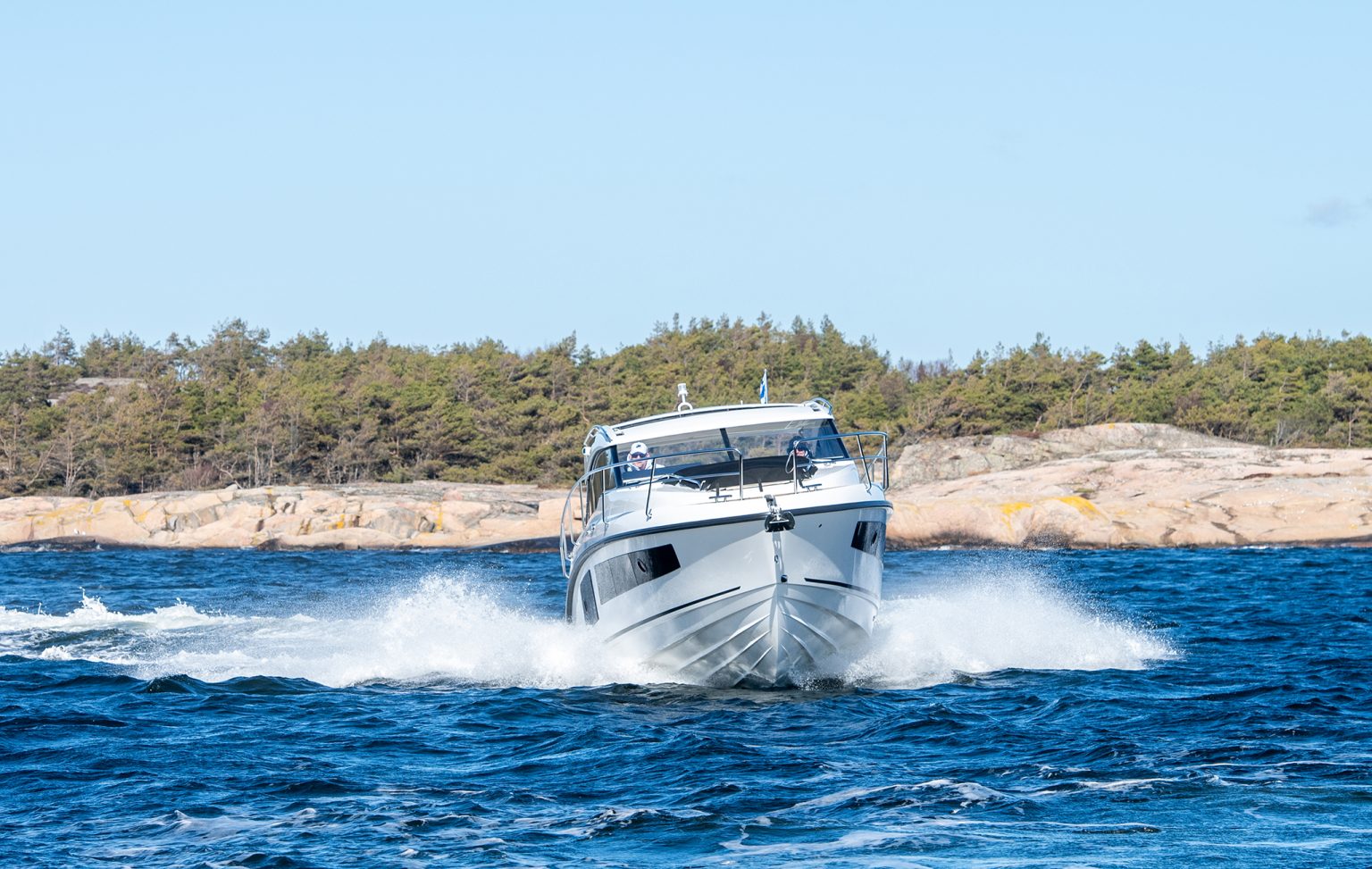 Head-on at speed, throwing spray either side