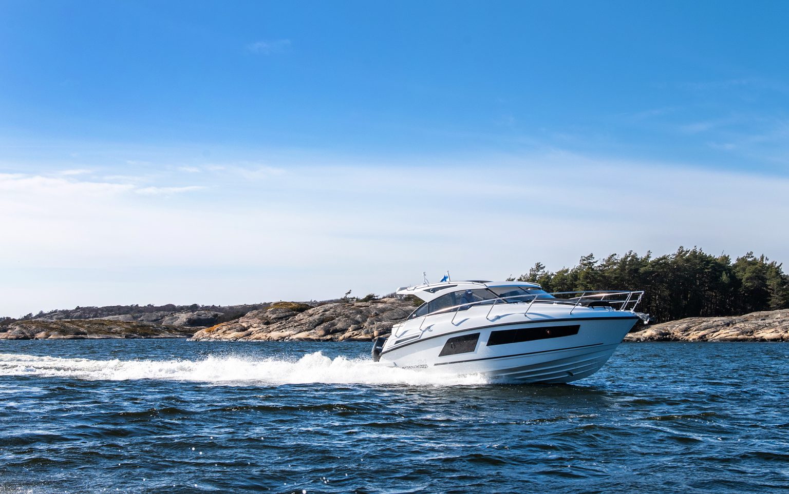 Passing bare granite rocks in flat water