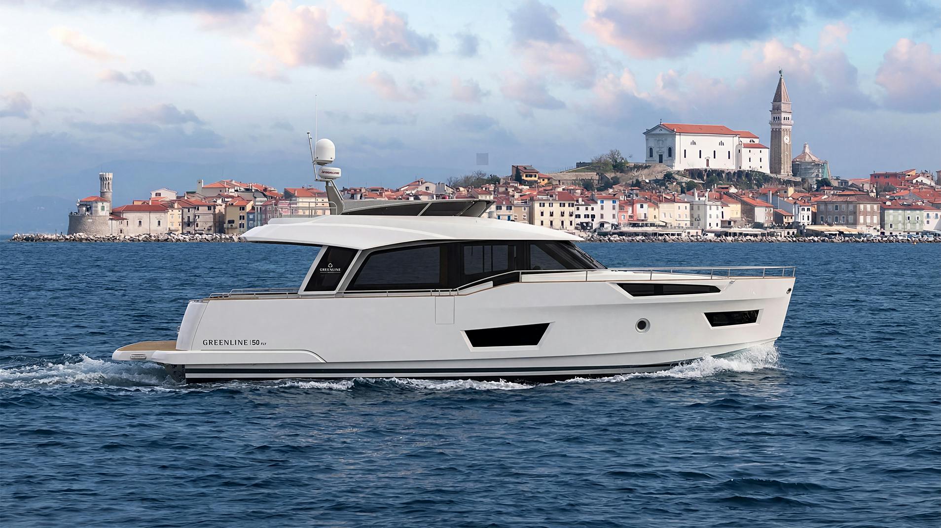 The 50 Fly lying off an old town waterfront with a church tower behind it
