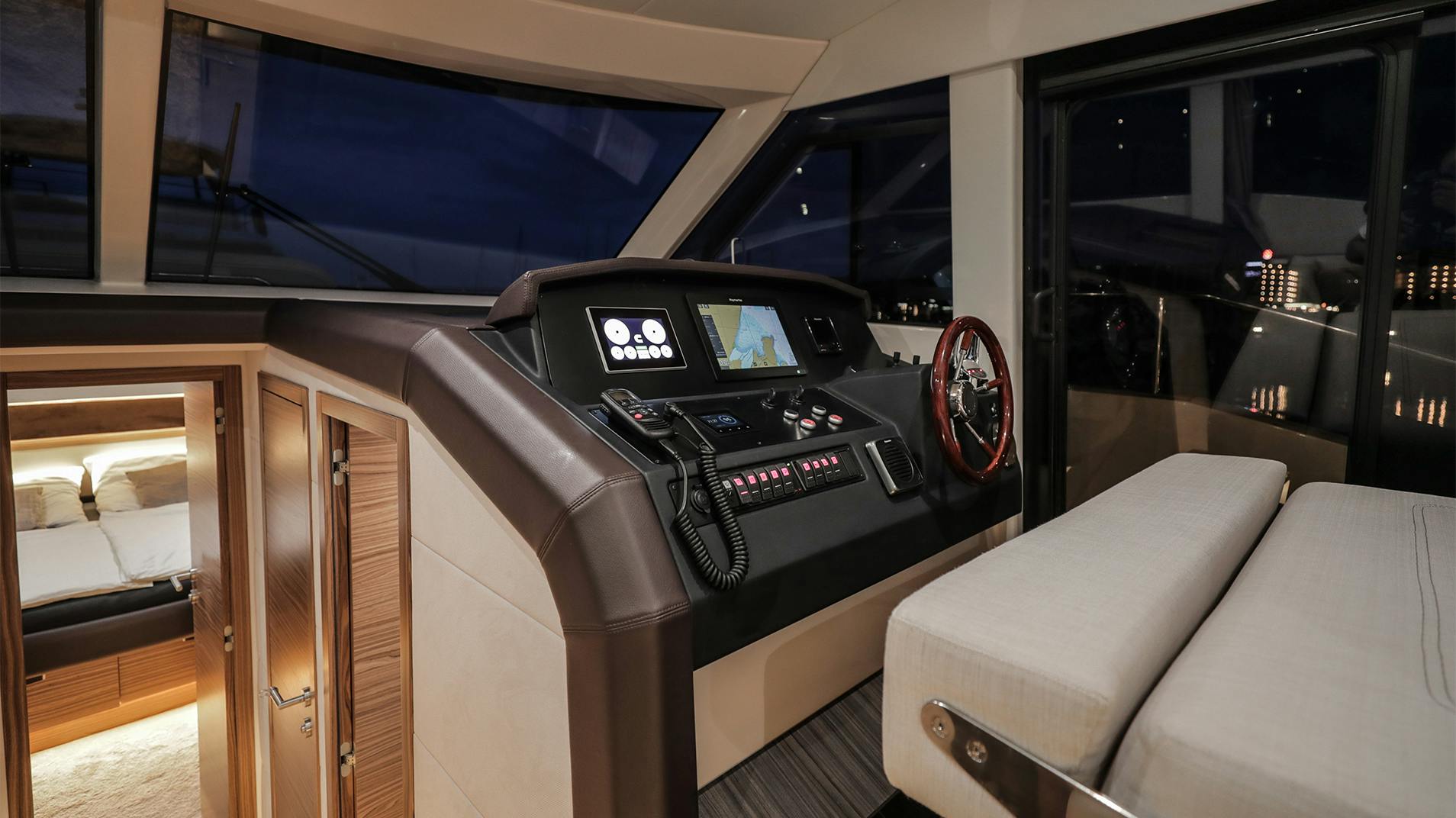 The helm, with the wheel, twin displays and a door out to the side deck