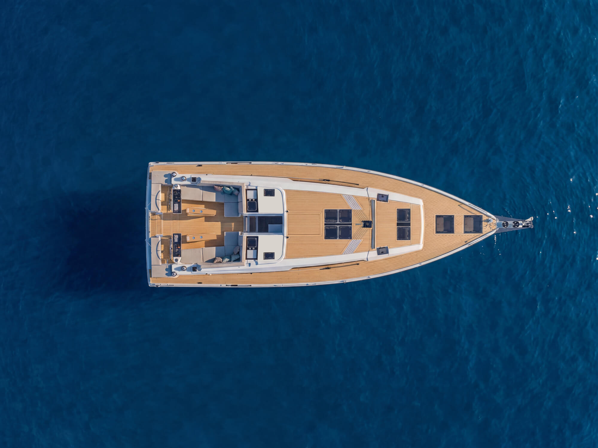 The deck seen straight down from above, with its teak decks and flush hatches