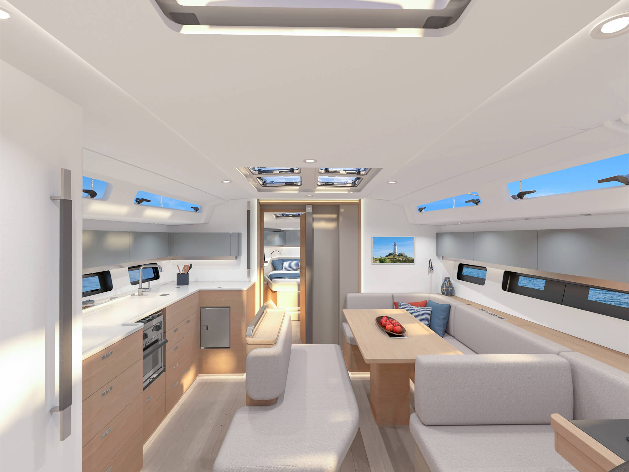 The saloon looking forward, galley to port and dining table to starboard under the overhead hatches