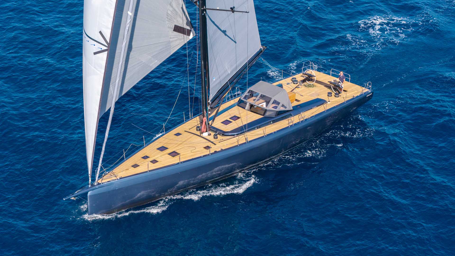The ICE 80 sailing under white sails in open water