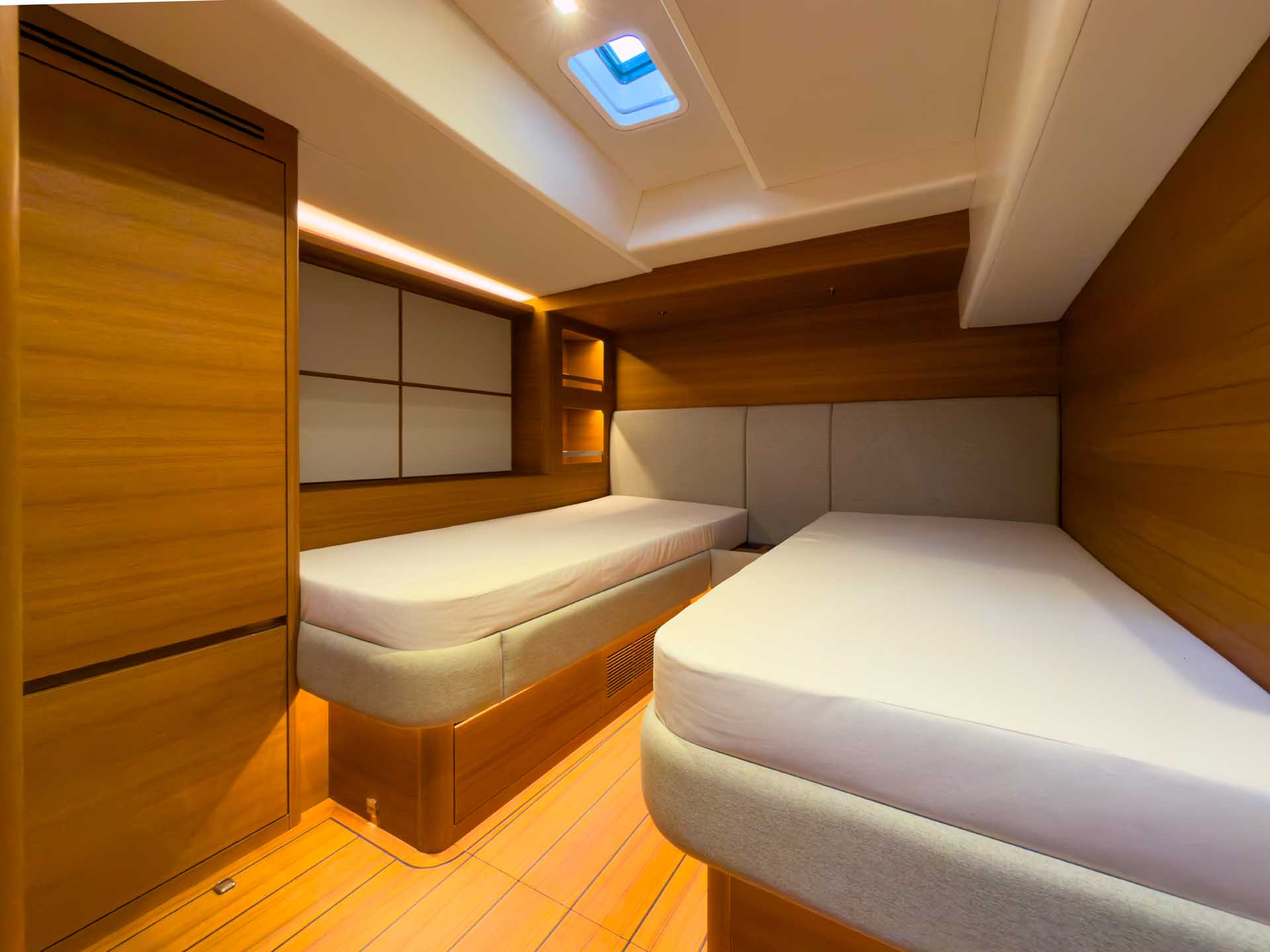 A cabin with two single berths and a hatch overhead