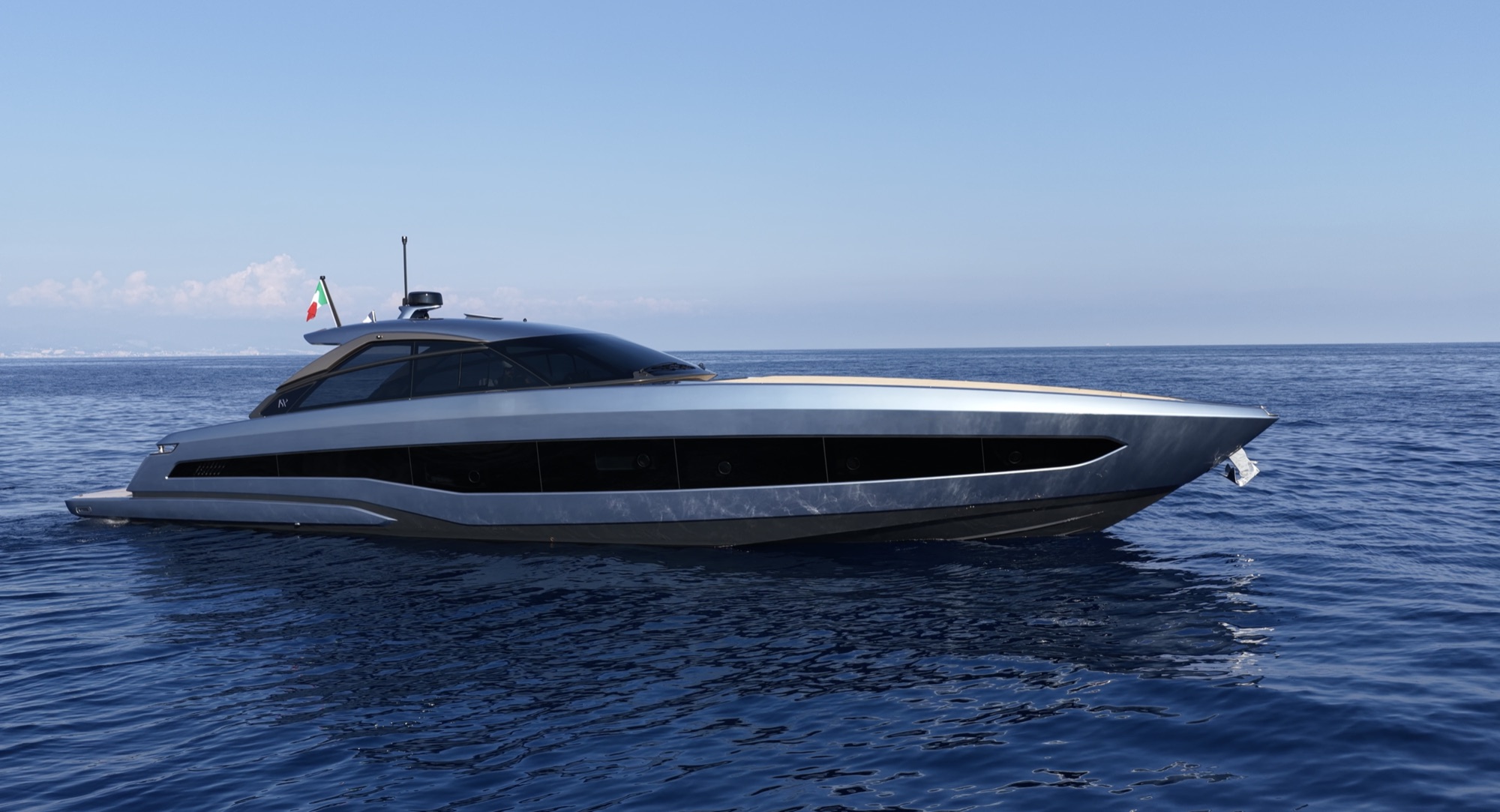 The GTO 70 lying still on a calm sea, its low silver profile side-on