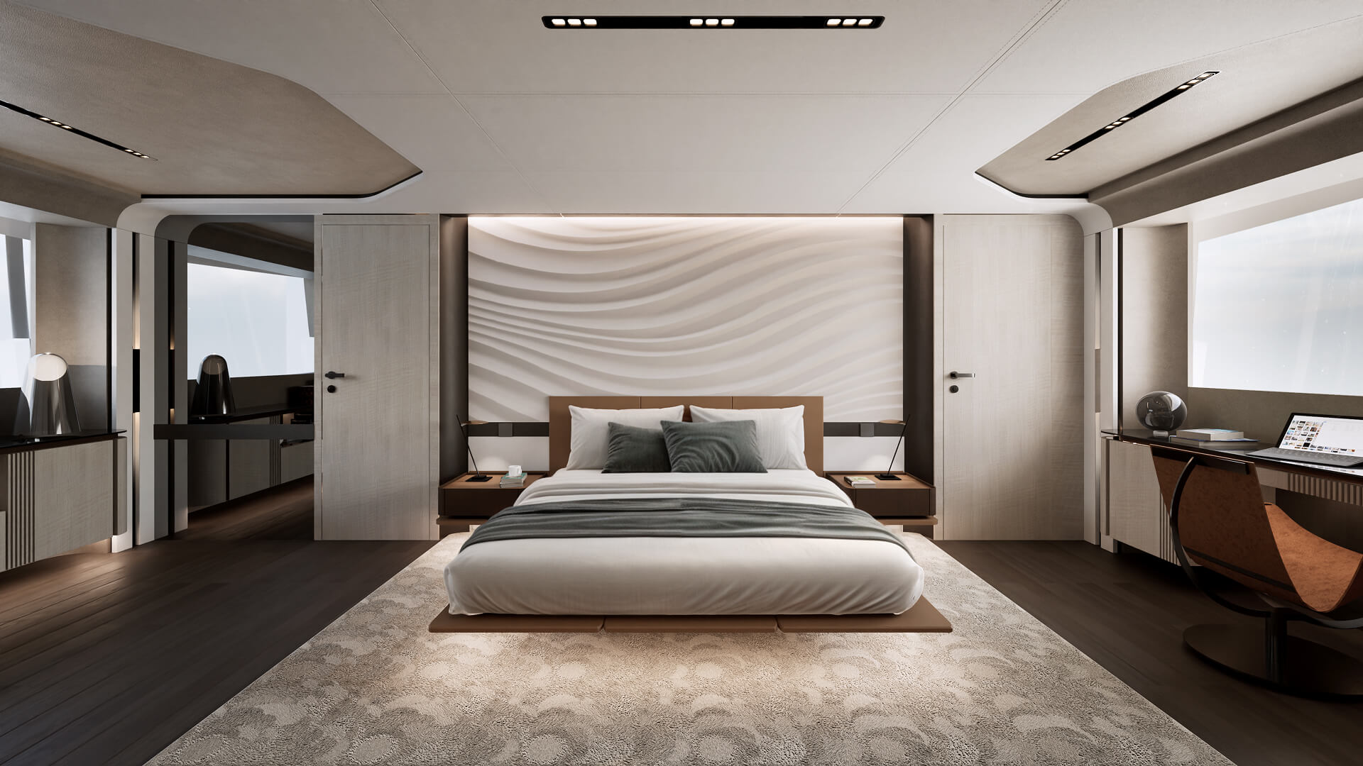 A double cabin with a desk to one side and a wave-patterned panel behind the bed