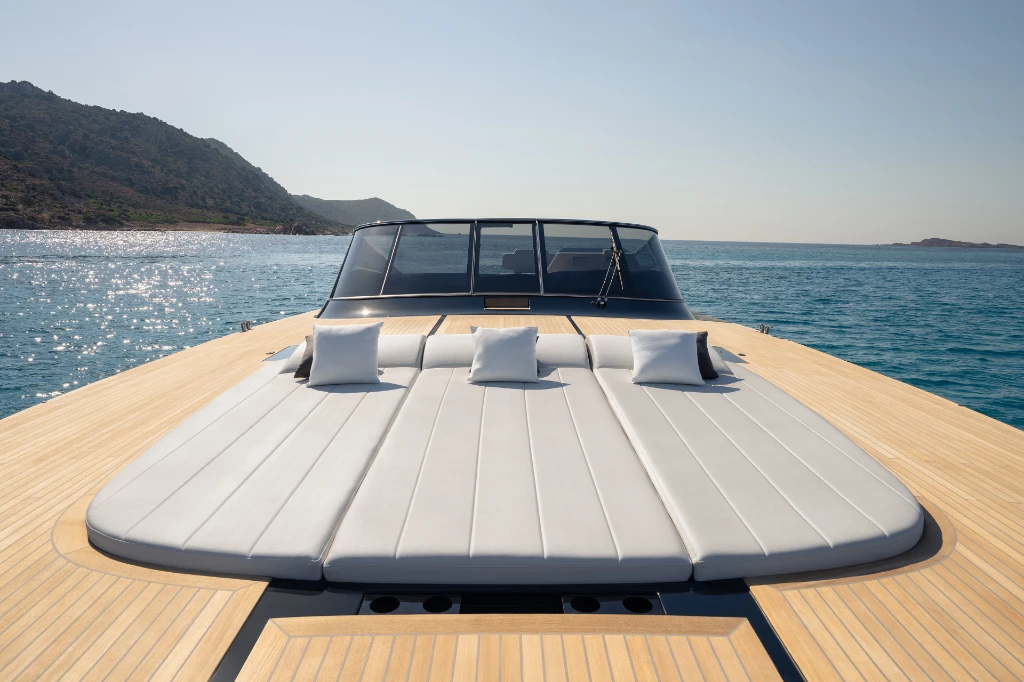 The bow sun pad, set flush into the teak foredeck, looking toward the back of the yacht and the windscreen
