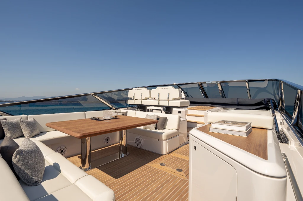 The cockpit looking forward, with the U-shaped lounge, dining table and the twin helm seats ahead
