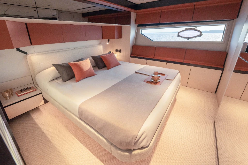 A double cabin below deck, with the linear hull window running the length of the bed