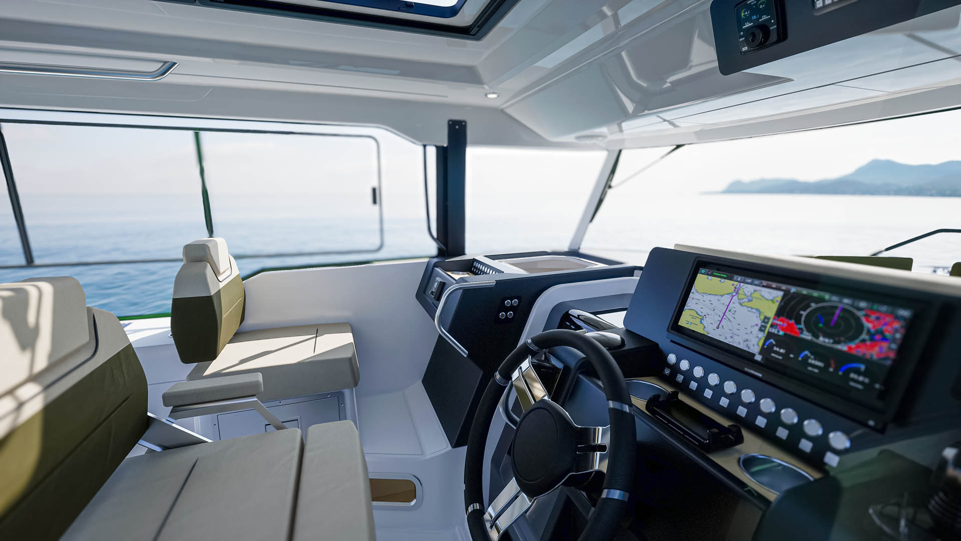 The helm, with the wheel, a wide chartplotter screen and a panoramic view forward