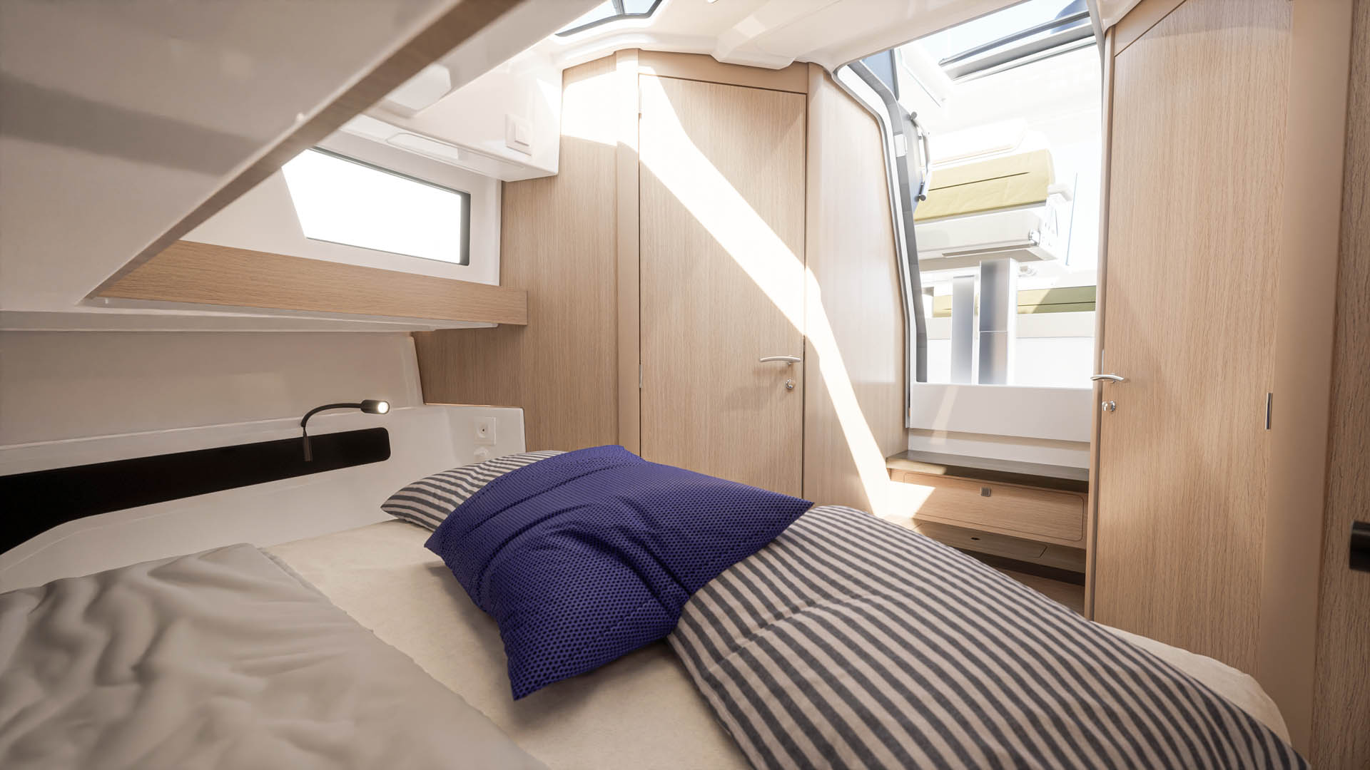 A double berth in the forward cabin, lit through a hull window