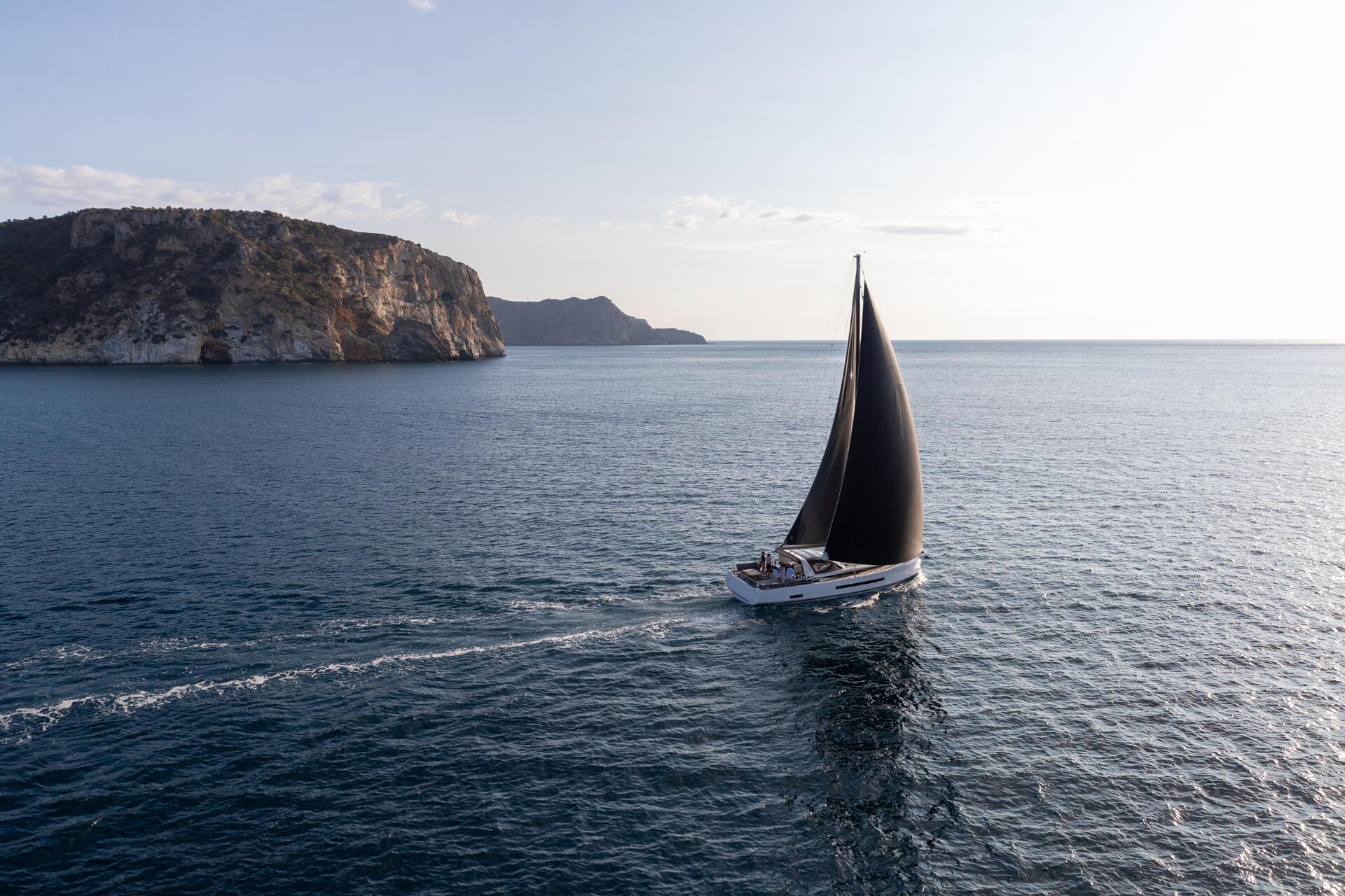 Sailing away on a flat sea, an island low on the horizon