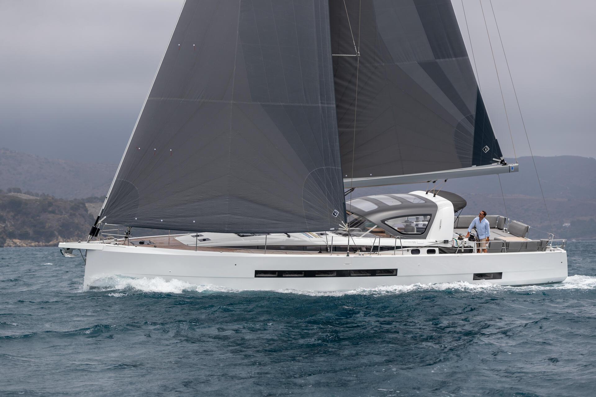 In profile under main and headsail, the long band of hull windows showing