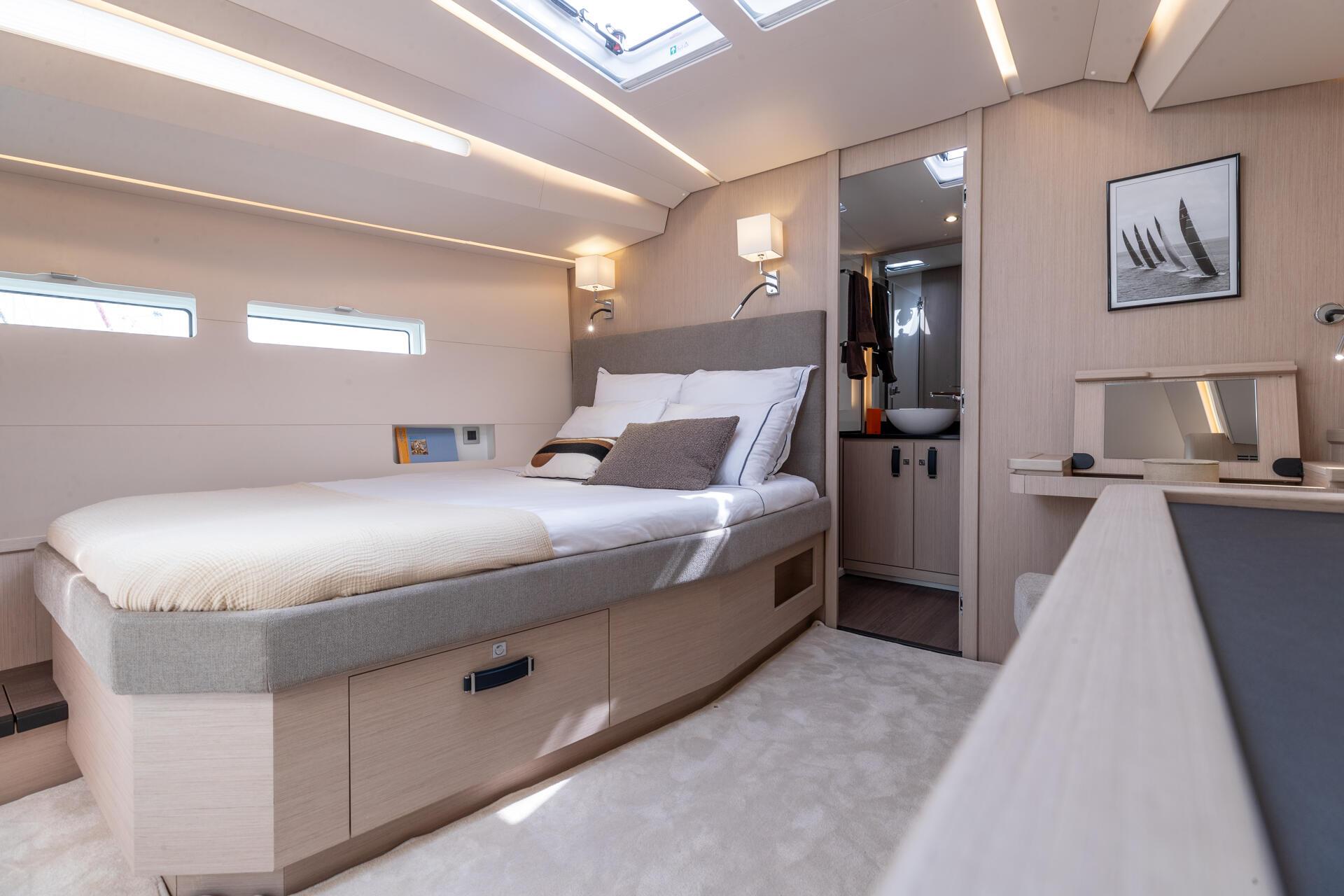 The owner's cabin, a double berth with a bathroom door beyond