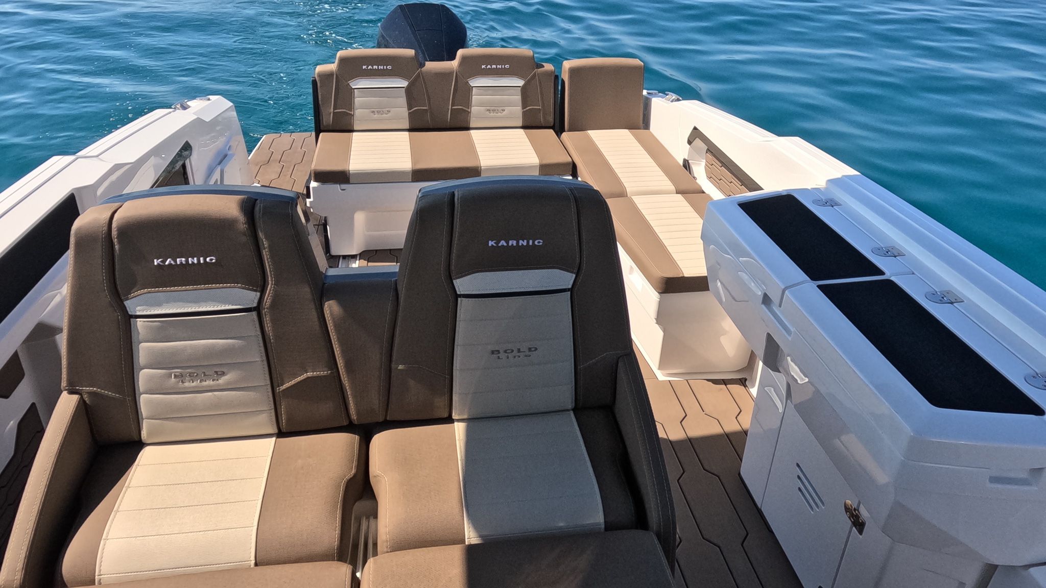The cockpit seen from above, with the aft sunpad, the seating around the helm and the outboard behind