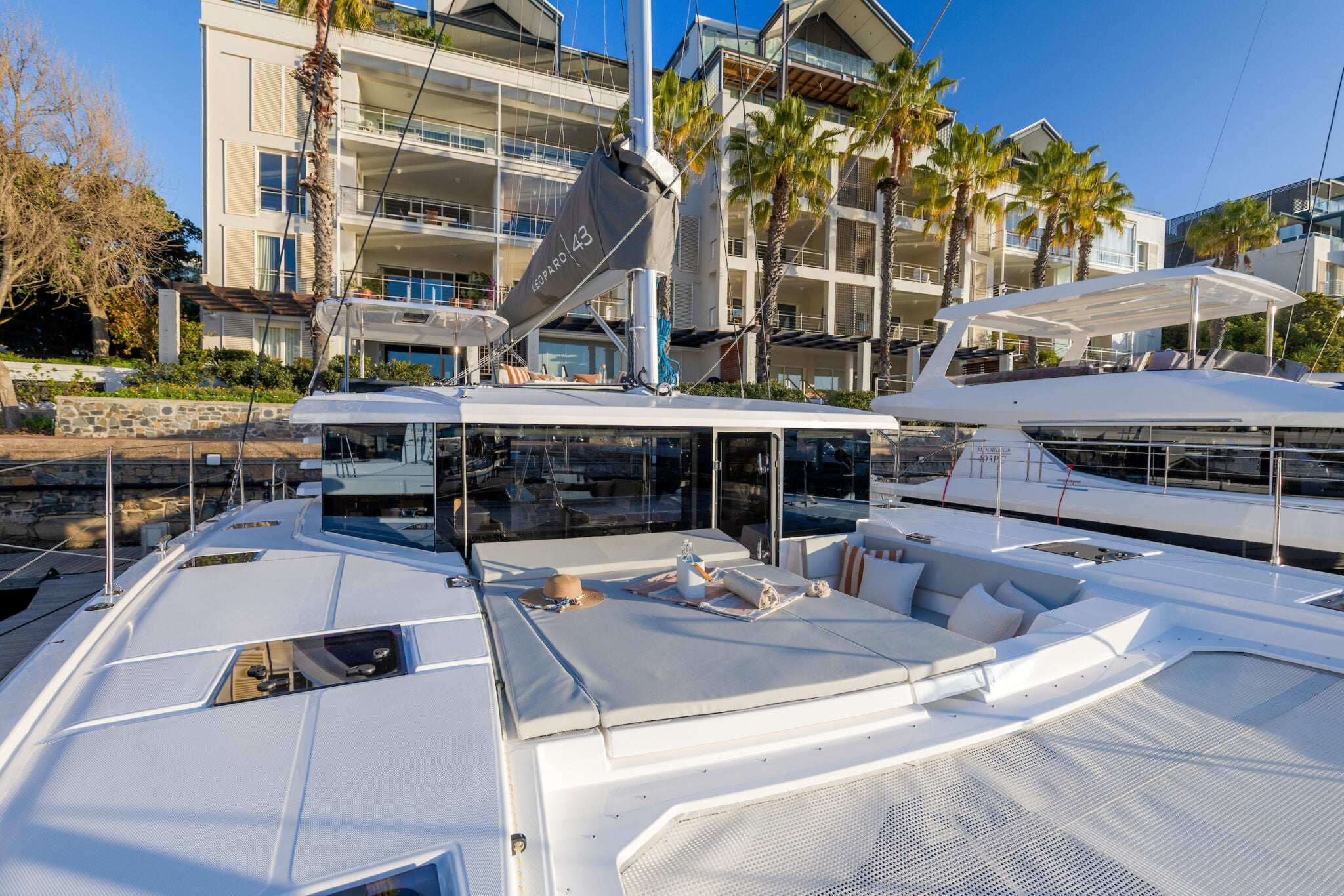 The forward cockpit seating ahead of the coachroof, with the marina behind
