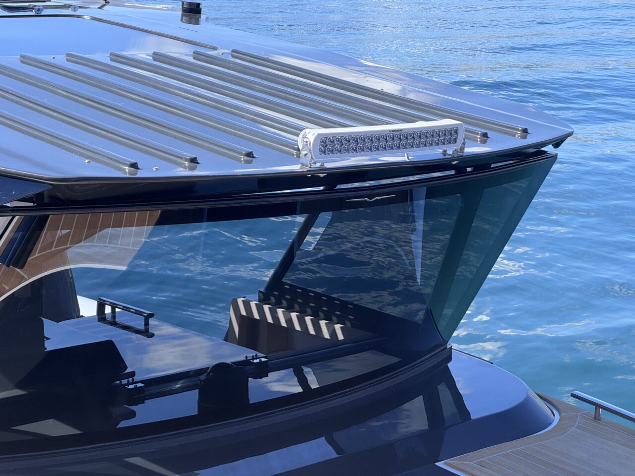 The wrap-around vertical windscreen and the structured hard top above it