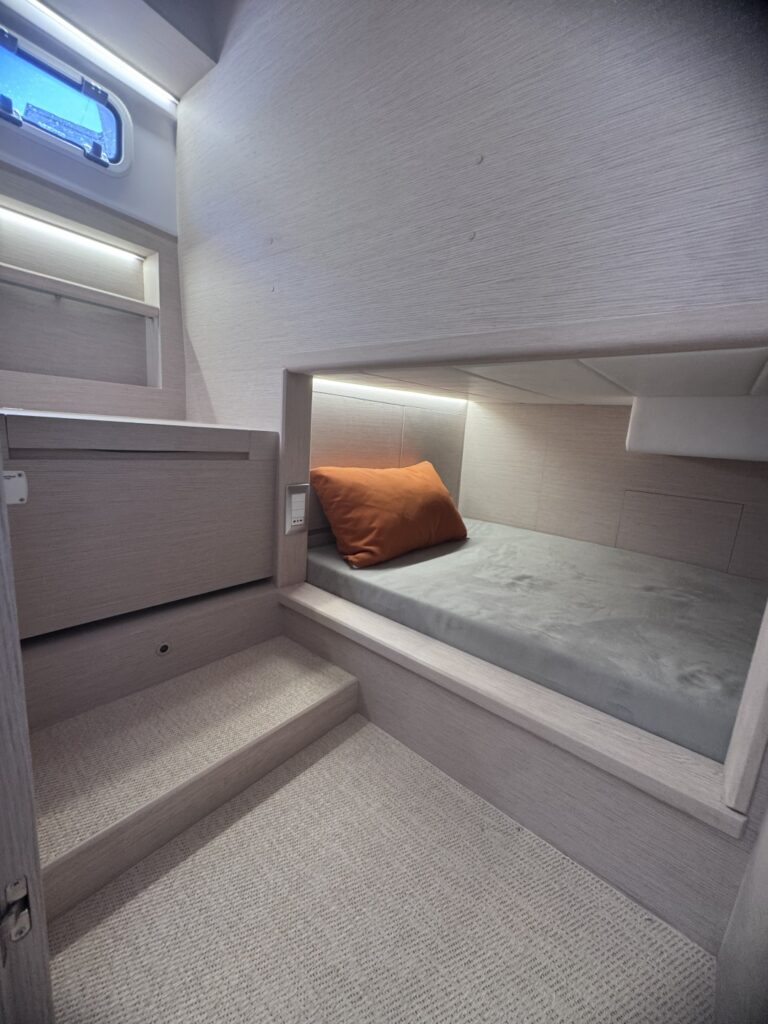 A berth in an alcove with a long hull window above it