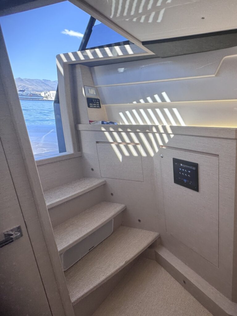 The companionway steps down from the deck, with a window alongside