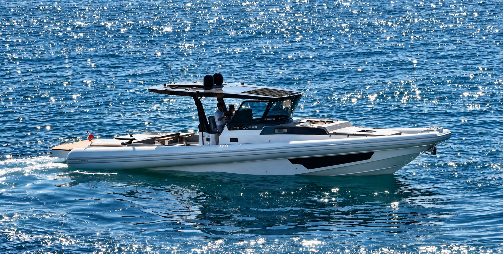 The MX-15 Explorer under way in profile, its hard top carrying solar panels above the helm