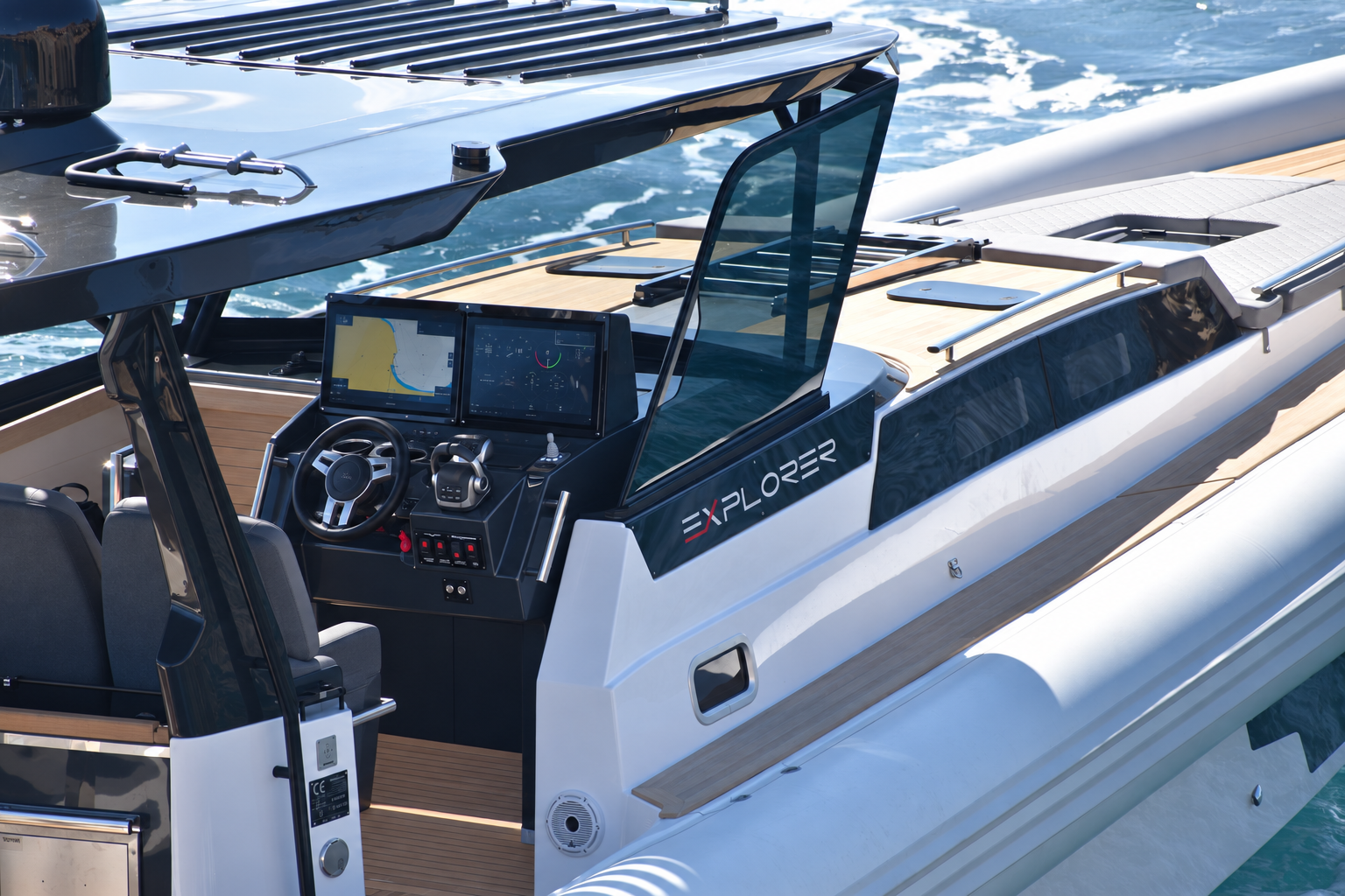 The helm from above, with the wraparound windscreen, twin displays and the wheel under the hard top