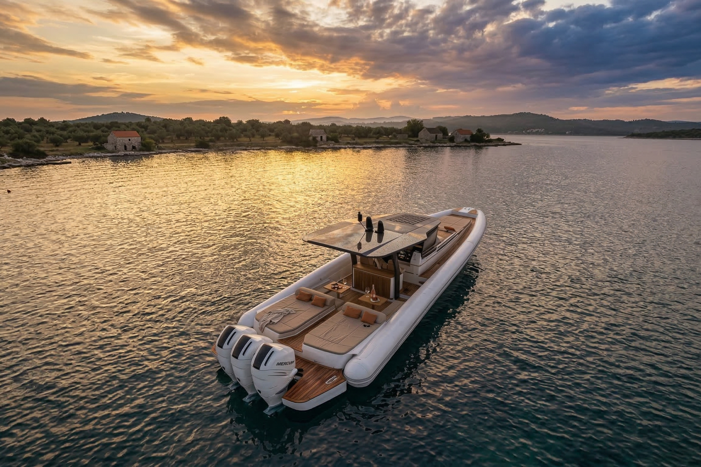 The MX-15 Explorer at anchor at sunset seen from astern, three outboards on the transom and the sunpads laid out forward of them