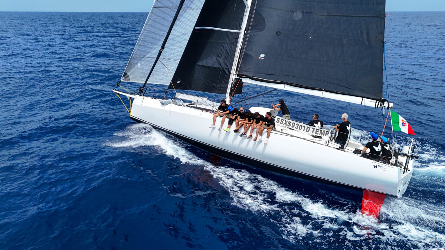The 520 Roma heeled with crew hiking on the windward rail