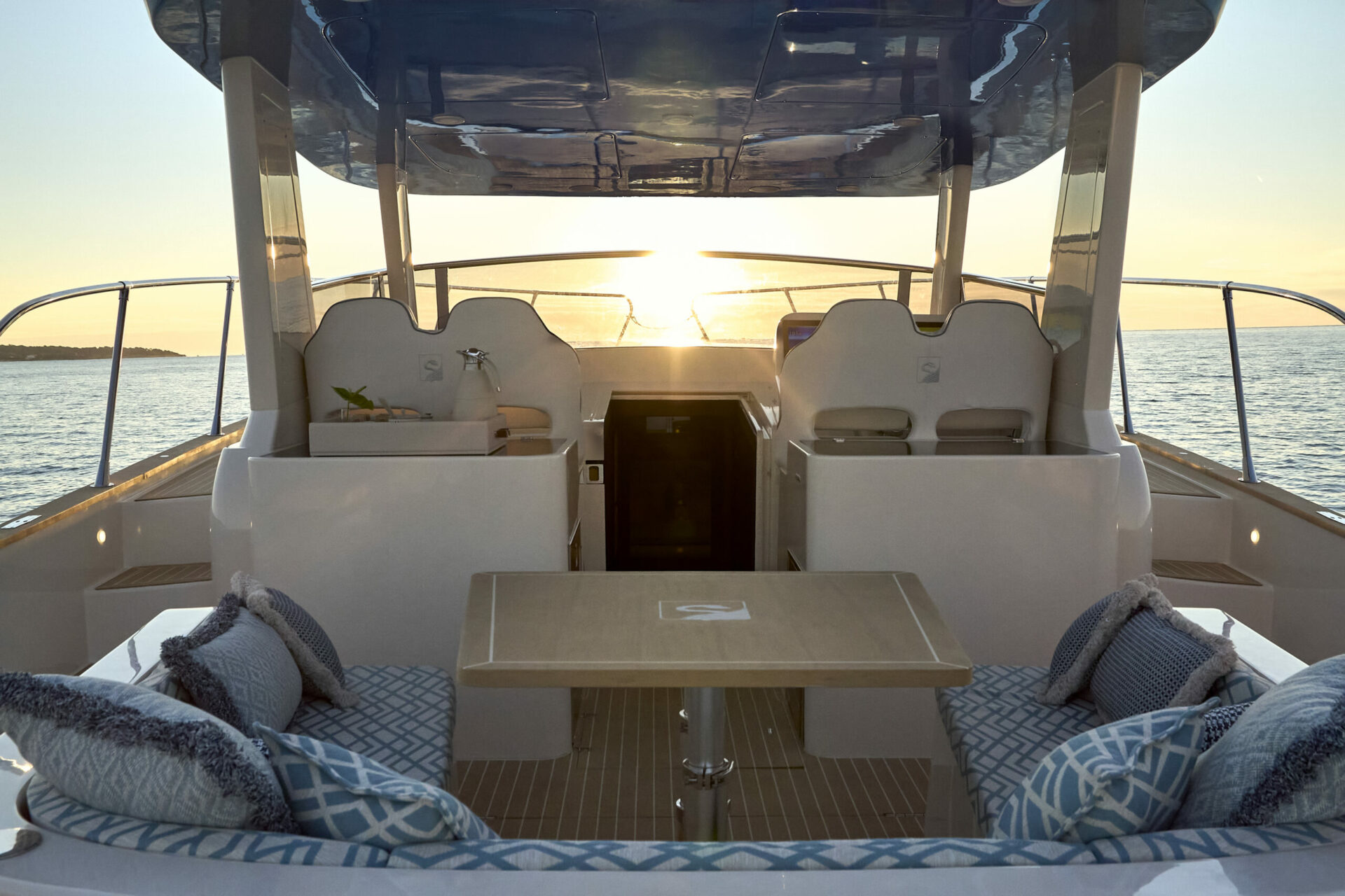 The cockpit dinette at sunset, under the T-top with the sun behind